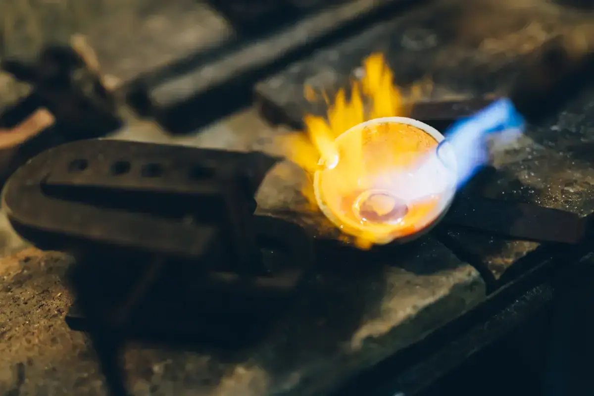 Professional <strong>jewelry repair Toronto</strong> service - Master jeweler conducting chain soldering with torch and precision tools